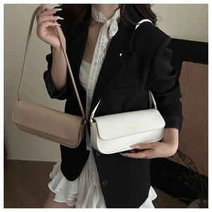 Detail of minimalist rectangular patent leather shoulder bags in beige and white