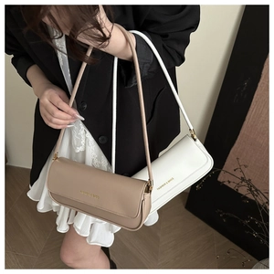 Detail of khaki and white baguette bags showing the Fashion & Bags gold lettering