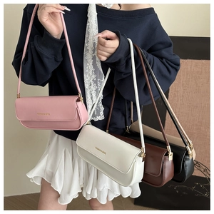 Close-up of four rectangular leather crossbody bags in pink, white, brown, and black colors