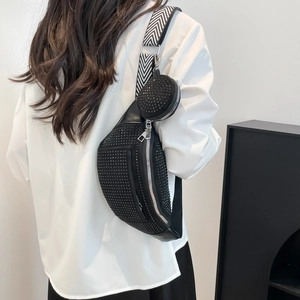 Black studded 2-in-1 chest bag with woven strap and small round pouch shown on model