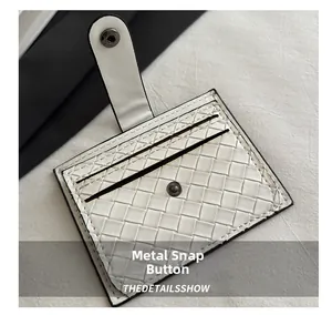 Detailed close-up of woven white leather wallet texture and metal snap button clasp