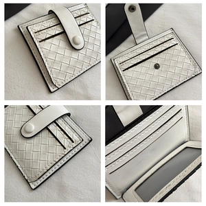 Detail of white woven texture clutch card holder with ID window and snap closure