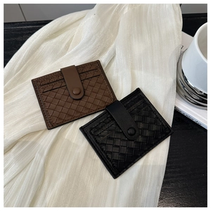 Detail of woven texture card holder with secure snap button and multi-card slot design