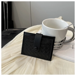 Detail of black woven texture driver license card holder with buckle closure on white cloth