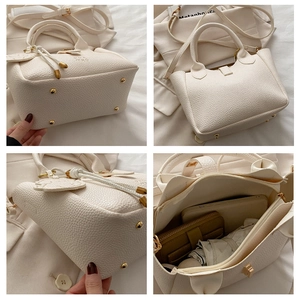 Detail of white lychee leather bucket bag with gold hardware and interior capacity