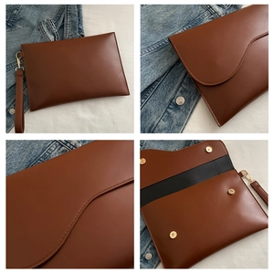 Detail view of brown PU leather envelope clutch with magnetic snaps and wristlet