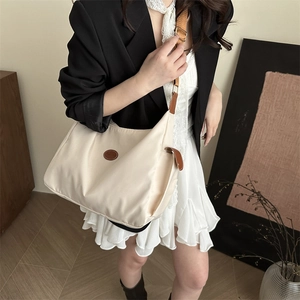 Fashionable cream large-capacity tote bag with brown leather trim and adjustable shoulder strap