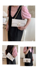 Detailed close-up of woven cream shoulder bag with golden H-buckle and metal chain strap