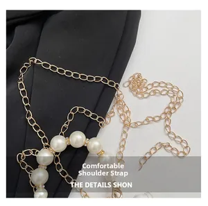 Detail of elegant pearl bag strap with gold metal chain and sparkling rhinestone accents