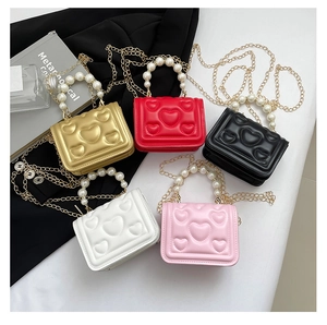 Detailed shot of five candy-colored heart-embossed mini bags with pearl handles and chains