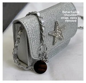 Close-up of silver sequin bag featuring a crystal star badge and metal chain strap