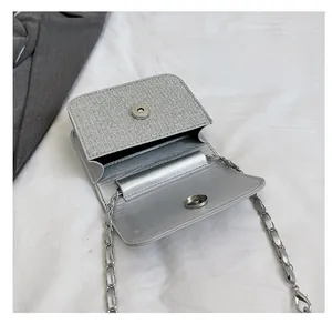 Top view of silver glitter crossbody bag showing interior compartment and chain strap
