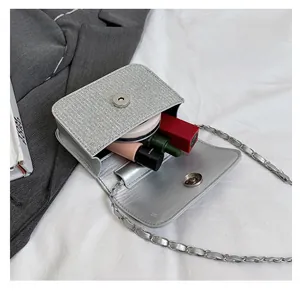 Silver woven chain bag interior view showing capacity for lipstick and cosmetics