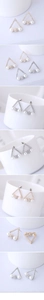 Macro view of triangle geometric stud earrings with small crystals and faux pearls