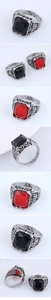 Macro view of vintage silver ring featuring ornate crown carvings and a large black gemstone