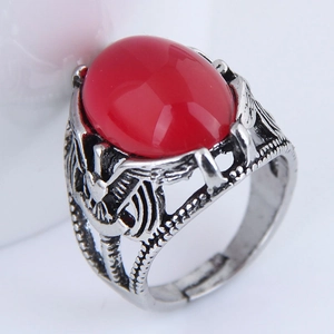 Macro shot of retro silver ring with eagle relief and large red oval gemstone