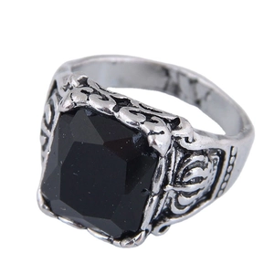 Vintage silver open ring with ornate relief patterns and a black gemstone center