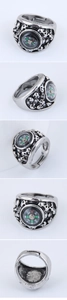 Macro detail of gothic compass ring featuring skull relief and adjustable open band