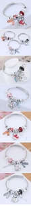 Close-up of beaded stainless steel bracelets with crystal charms like swan and heart