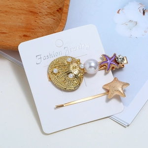 Set di fermagli per capelli con conchiglia dorata e stella marina con perle