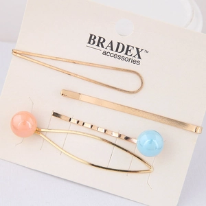 Driedelige gouden haarspeldjesset met pastelkleurige parels op displaykaart