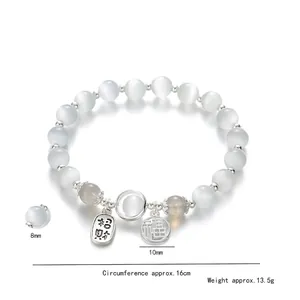 Cat eye stone bead bracelet with silver pendants featuring fortune and luck charms