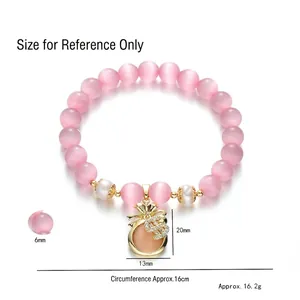 Bracelet en œil de chat rose avec perles d'eau douce et pendentif sac d'argent doré
