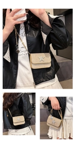 Detail of gold sequin mini crossbody bag with a sparkling rhinestone star emblem