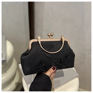 Detail of butterfly embroidery on black lace cheongsam bag with golden handle