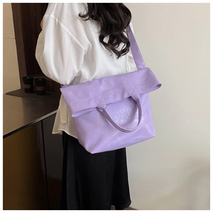 Detail of lavender soft leather tote bag with unique folded top and crossbody strap