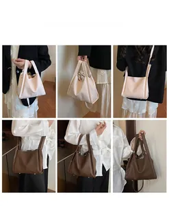 Detail view of lychee texture bucket bag showing crossbody and handheld styles