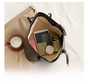 Interior view of large capacity dark brown monogram tote bag showing spacious storage space