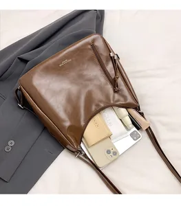 Brown leather tote bag interior showing large capacity for phone and cosmetics