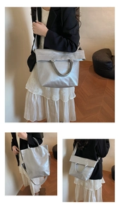 Detail showing the shiny metallic silver texture and versatile straps of the large tote bag