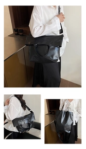 Detail of black faux leather tote bag showing soft texture and versatile folding design