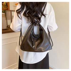 Close-up of a large dark brown soft leather tote bag with FASHION & BAGS logo detail