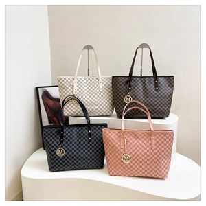 Macro shot of stylish tote bags in four colors with repeating M pattern and gold pendant