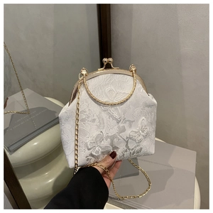 Detail of vintage frame bag with 3D butterfly appliques and elegant gold chain handle