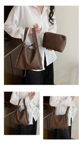 Detail of dark brown litchi pattern leather tote bag set with metal base studs