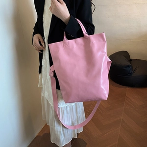 Pink glossy faux leather tote bag with adjustable straps for shoulder and hand carry
