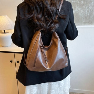 Brown large-capacity vintage PU leather tote bag with functional zippers and drawstring