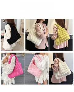 Detail view of large bubble textured tote bags available in multiple vibrant colors