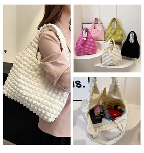 Detail of puffy bubble shoulder bags showing 3D textured fabric in five vibrant colors