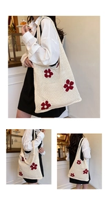 Detail of hand-crocheted cream tote bag with vibrant red floral patterns and texture