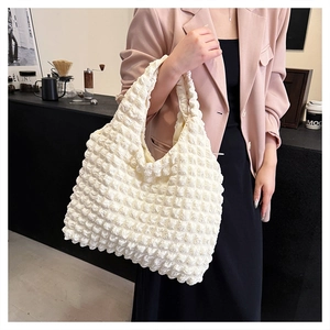 Close-up of cream white bubble texture tote bag with a unique popcorn fabric detail