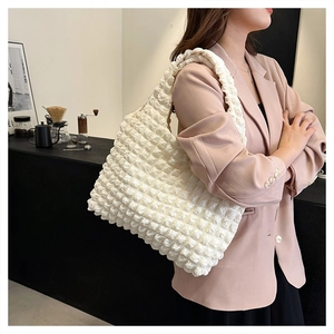 Close-up of cream bubble texture nylon tote bag showing pleated fabric detail