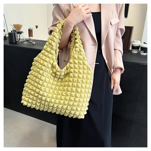 Detailed texture of lemon yellow bubble pleated tote bag in soft popcorn fabric
