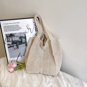 Detailed knit texture of beige crochet hollow out tote bag for casual summer style