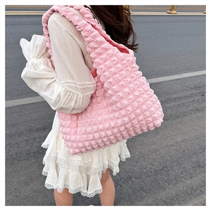 Detailed side view of pink bubble texture tote bag showing soft ruffled fabric