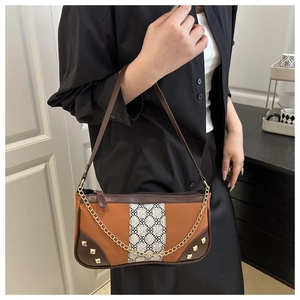 Detail of vintage square shoulder bag with geometric fabric strip and gold chain strap